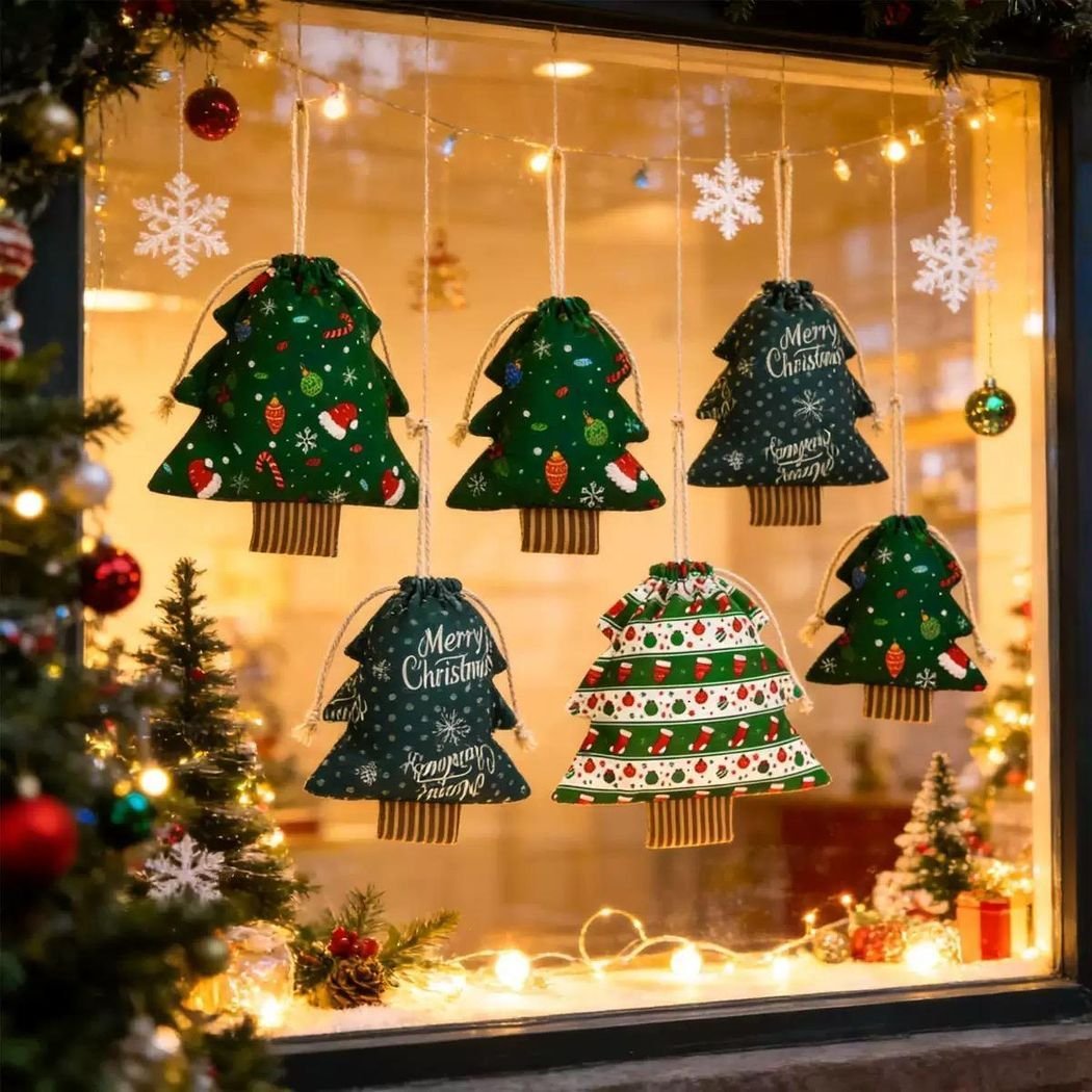Tree-shaped fabric Christmas hanging decorations displayed in a window